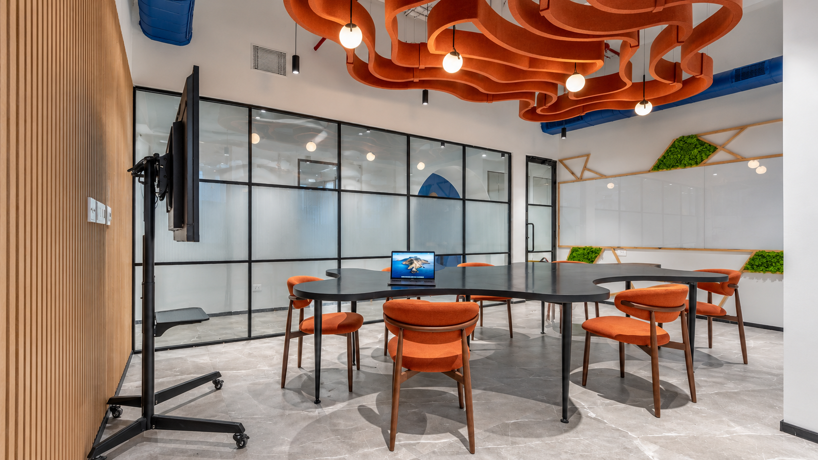 Collaboration meeting room with sculptural acoustic ceiling on a completed office floor